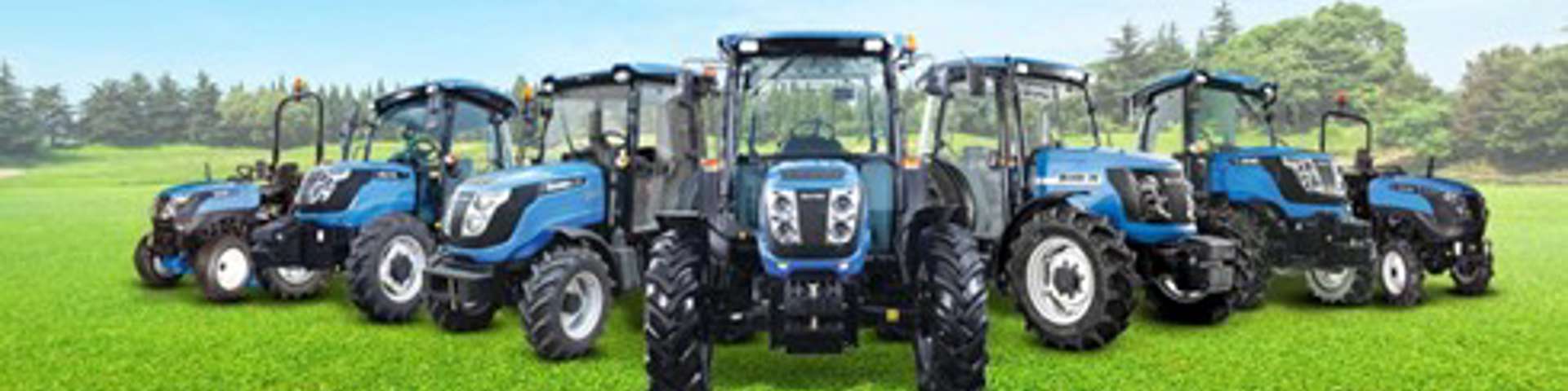 Blue Solis tractors lined up in a field under clear skies, showcasing compact utility models.