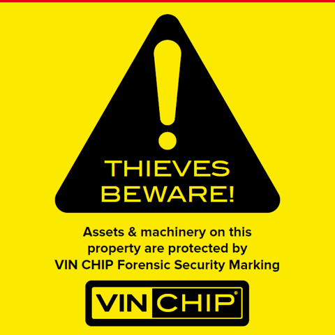 Bold VIN CHIP warning sign in red, black, and yellow, alerting thieves to security measures.