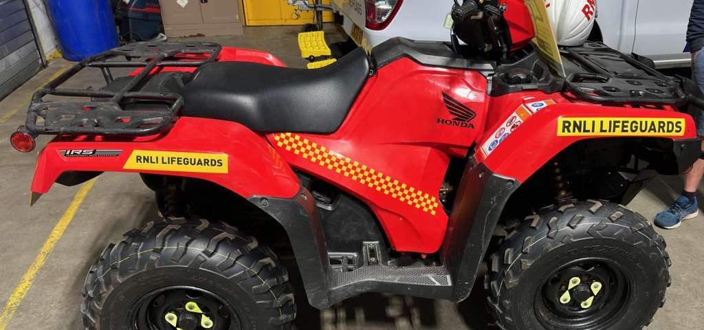 RNLI red Honda quadbike used for beach patrol and lifesaving operations on Merseyside