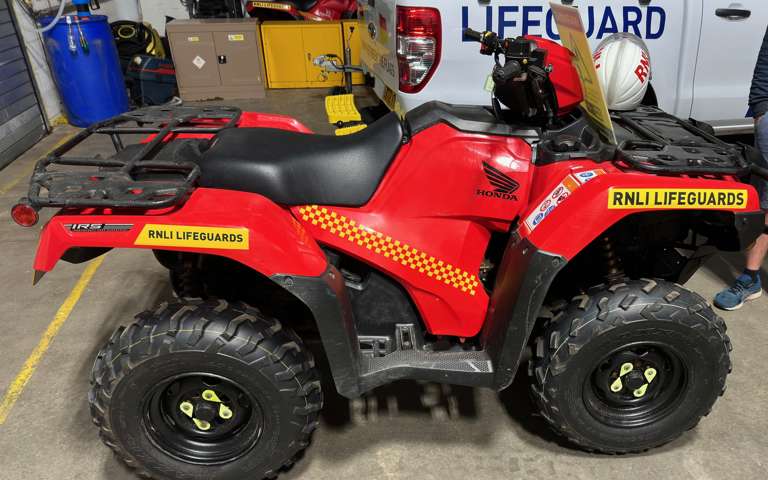 RNLI red Honda quadbike used for beach patrol and lifesaving operations on Merseyside