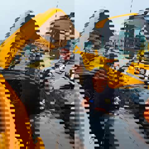 Nick Mayell instructing a group during hands-on training, all wearing winter coats and hats.