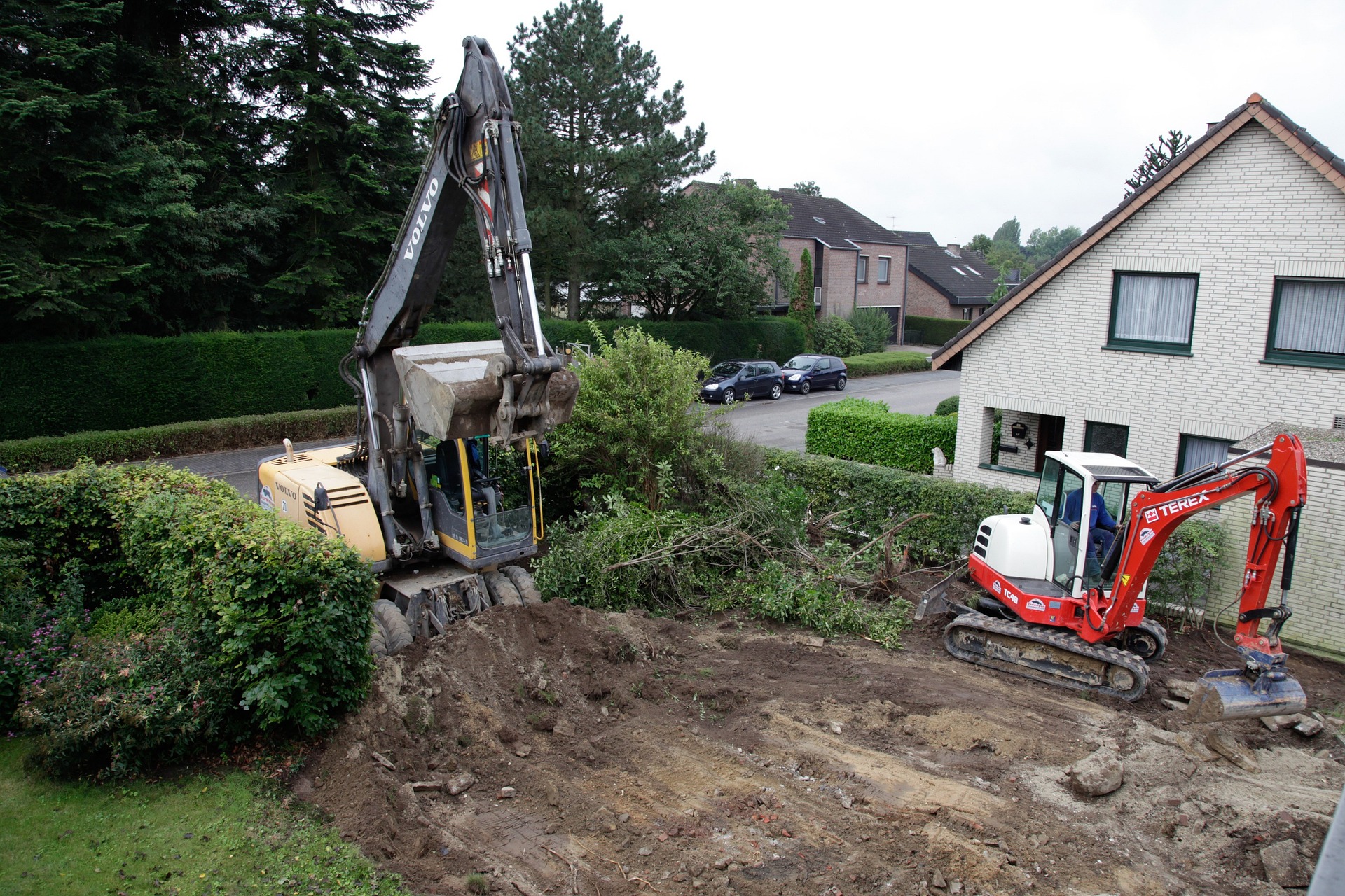 Construction crew working on a residential project in a garden area.