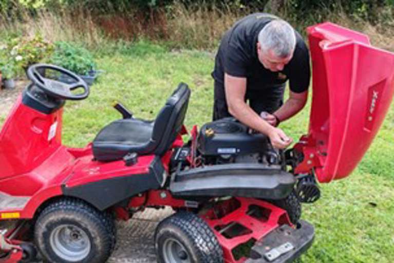 Installing a VIN CHIP security system on a red Solo/Alko ride-on lawn mower.