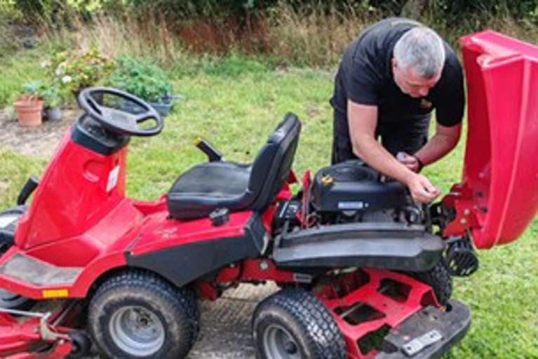 Installing a VIN CHIP security system on a red Solo/Alko ride-on lawn mower.