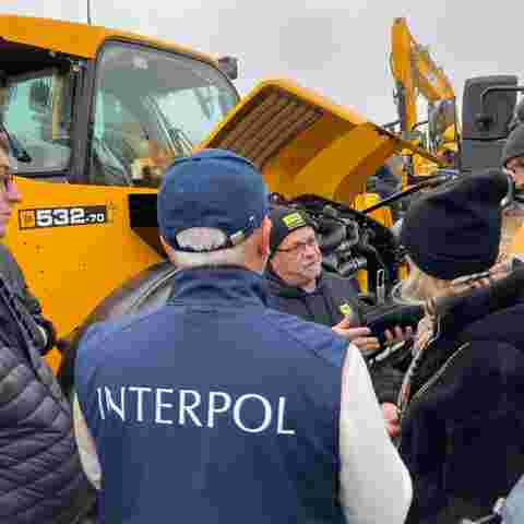 Trainer Nick Mayell providing practical training near yellow heavy plant machinery.