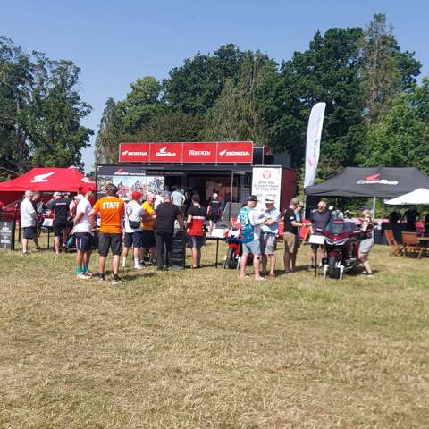 Visitors exploring motorcycle and refreshment exhibitor stands at the Adventure Bike Rider Festival 2026.